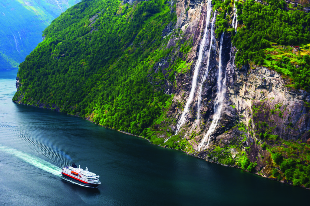 A Hurtigrten ship cruising a fjord in Norway